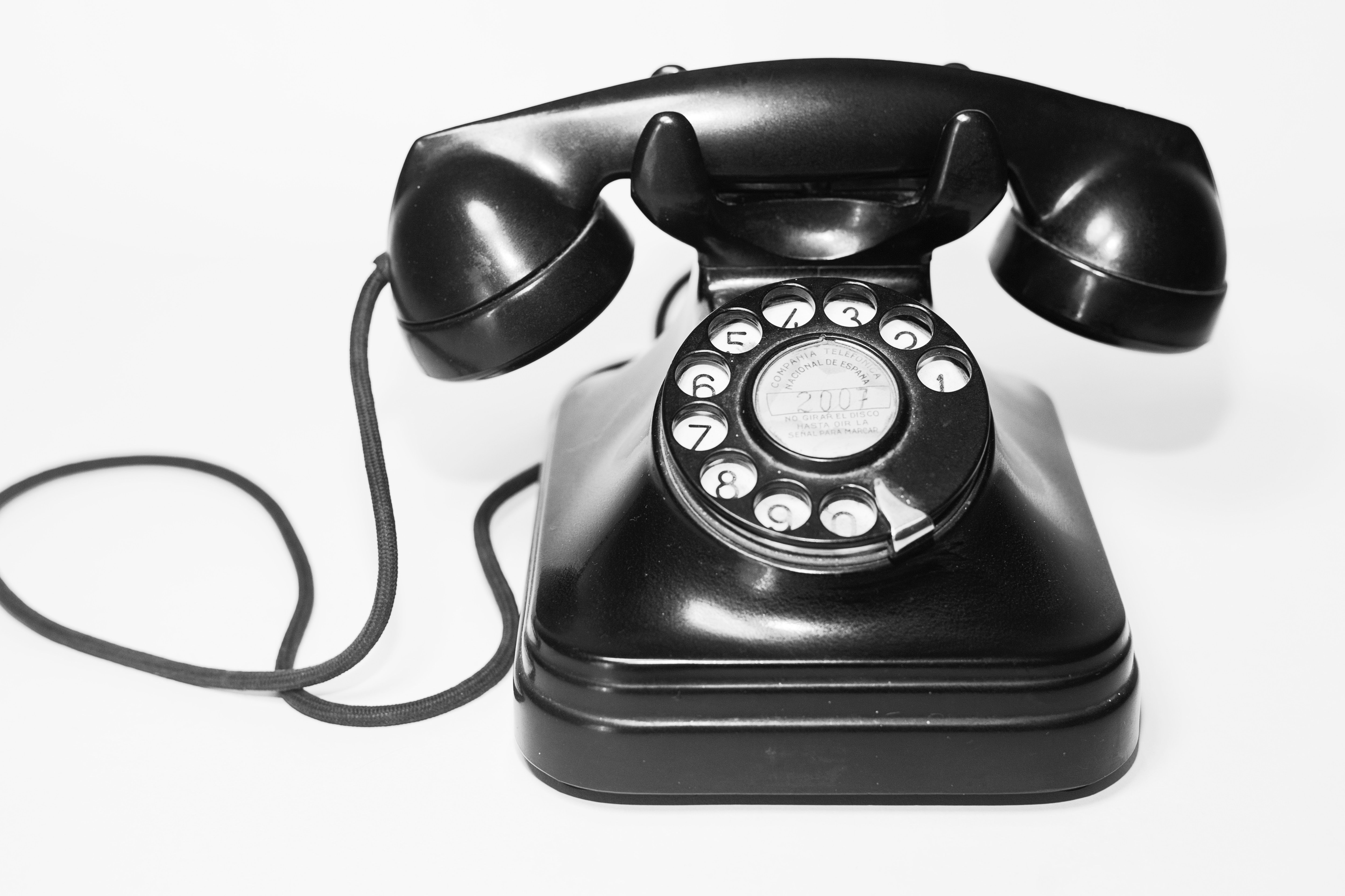 Vintage black telephone on white background