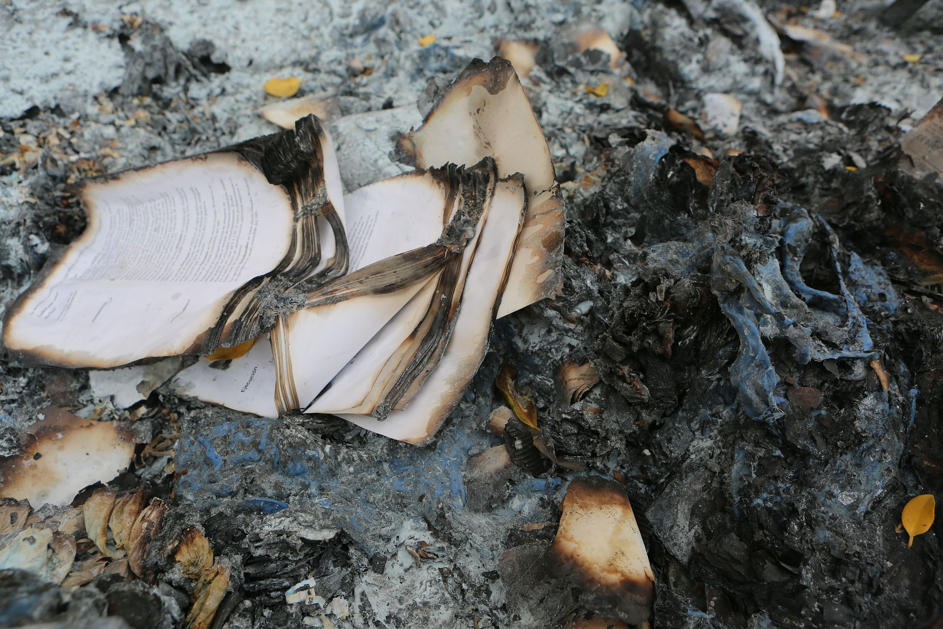 Burnt paper and ashes in a pile on the floor