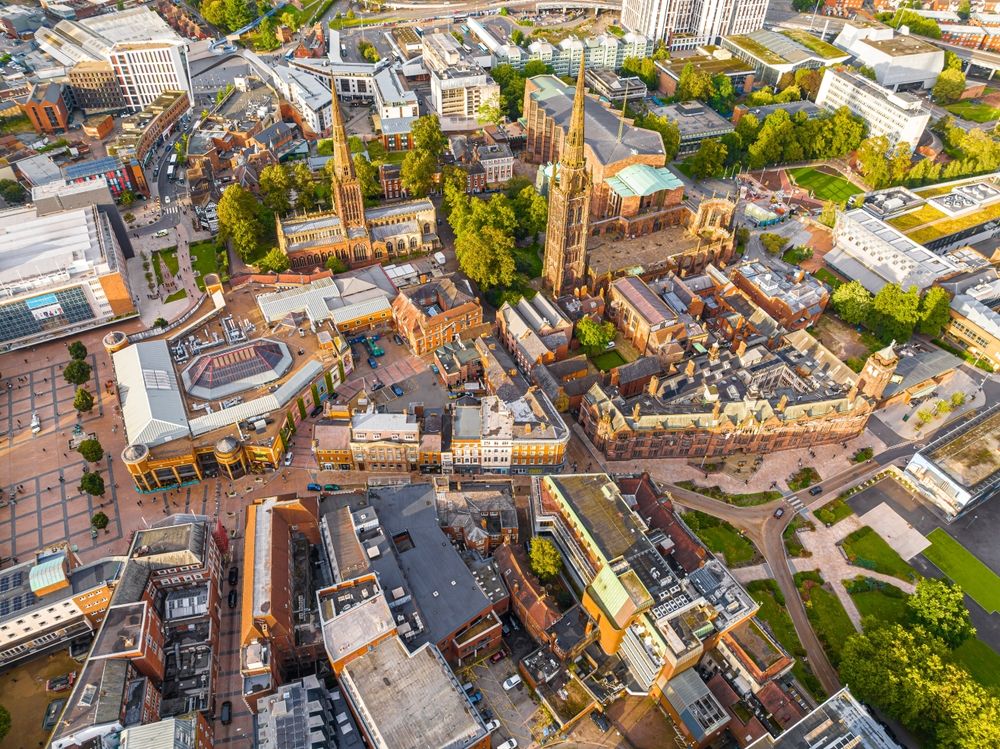 Coventry in West Midlands, England. Old town aerial view from ruined cathedral tower. Prominent Holy Trinity Church.