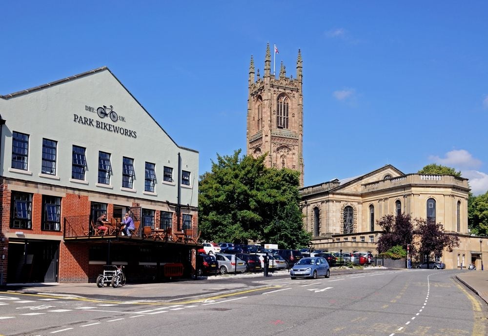 DERBY, UNITED KINGDOM - The Cathedral of All Saints with a bike shop and cafe to the left hand side, Derby, Derbyshire, England, UK, Western Europe.