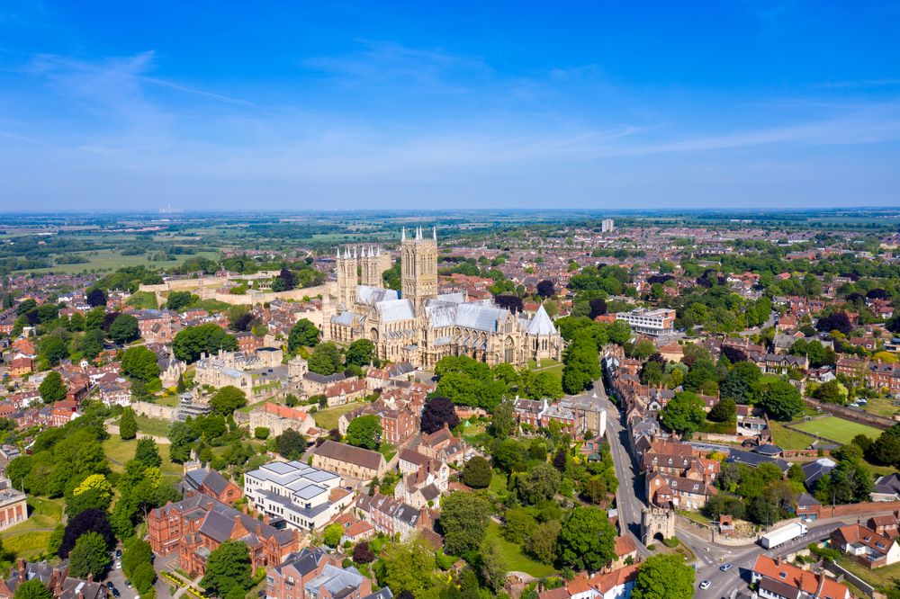 erial photo of the city centre of Lincoln and Lincoln Cathedral, Lincoln Minster in the city centre of Lincoln on a bright sunny summers day showing the historic Cathedral Church in the city centre