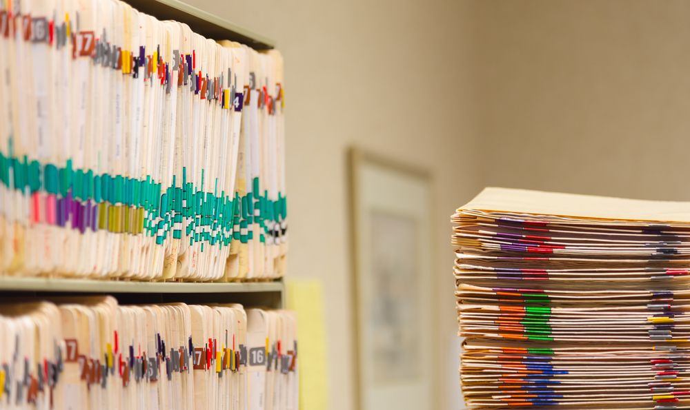Medical Records folder archive organised in the file cabinet all in a row